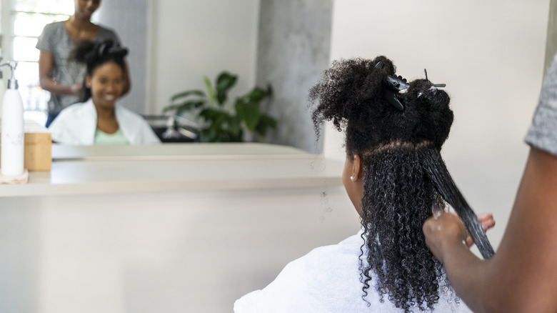 A woman trimming her hair