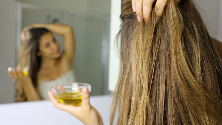 A woman using oil on hair