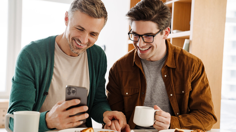 smiling couple with smartphone