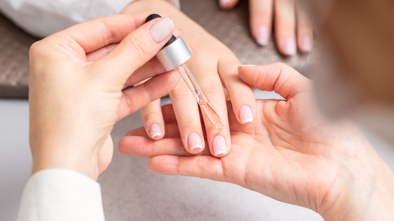 Person using cuticle oil 