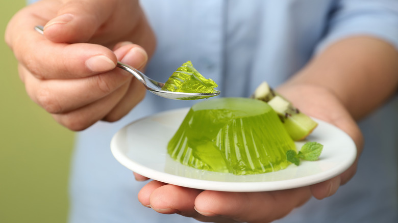 Person eating green jello