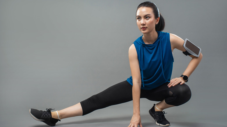 woman lunging into stretch