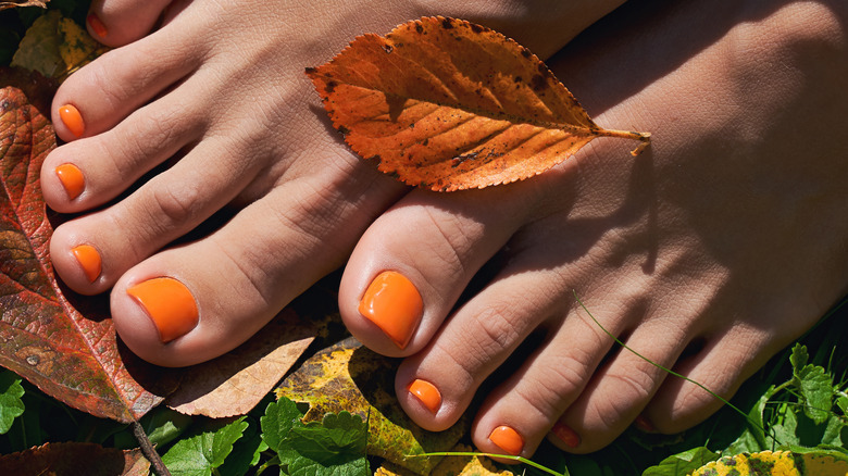 orange pedicure with fall leaves