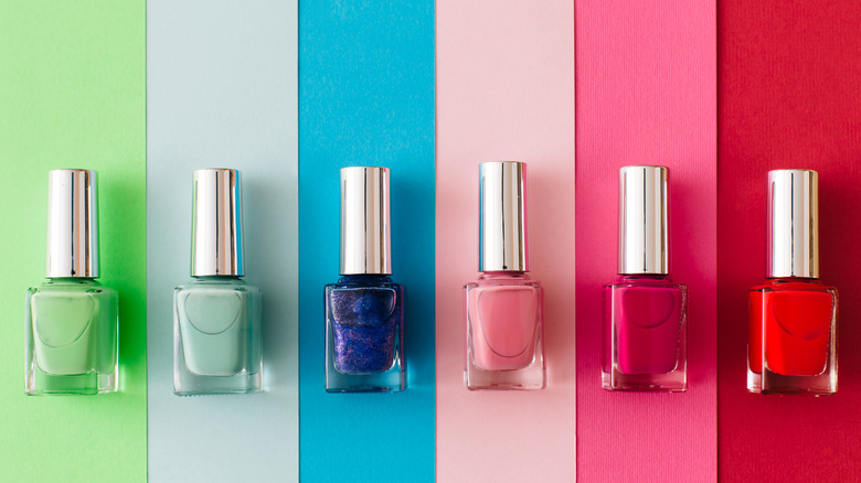 nail bottles on colorful background