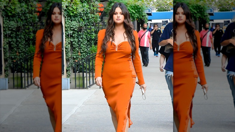 Selena Gomez wearing orange dress