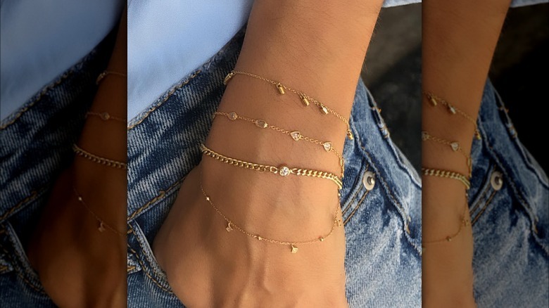 Girl wearing a delicate stack of bracelets