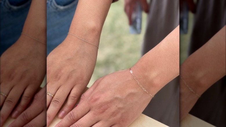 People wearing permanent chain bracelets