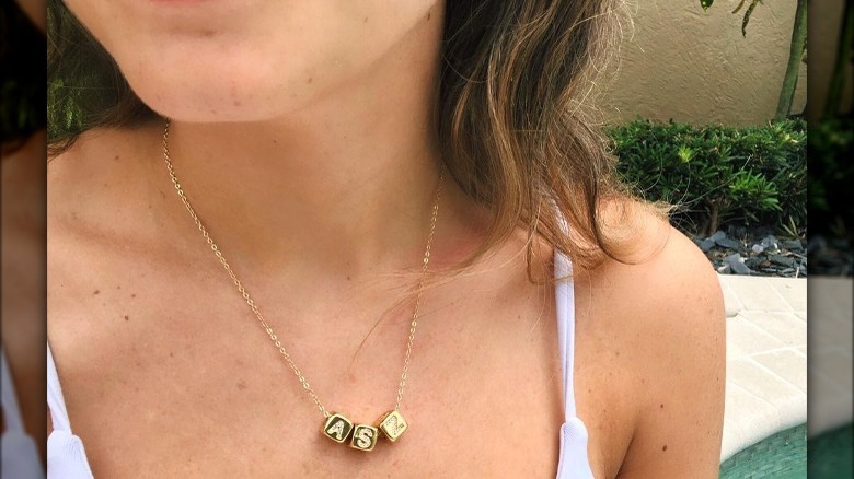 woman wearing letter block necklace