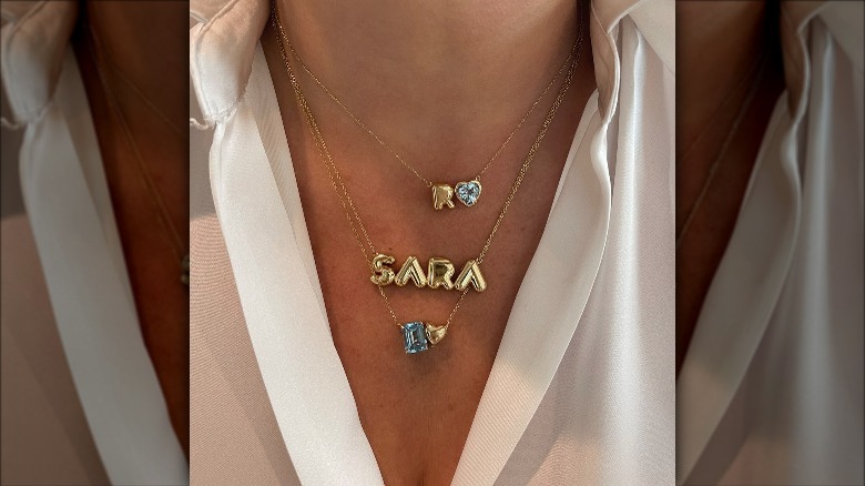 woman wearing balloon font necklace