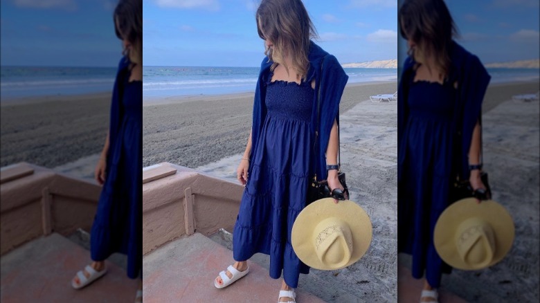 Woman posing in navy nap dress