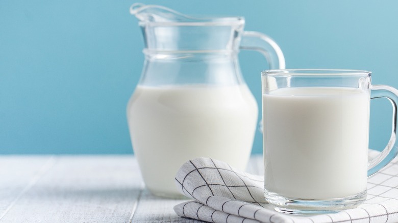 Glass and pitcher of milk