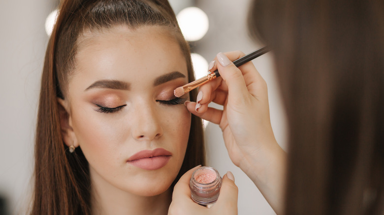 makeup artist applying eyeshadow