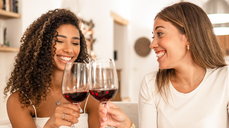 two happy women drinking wine