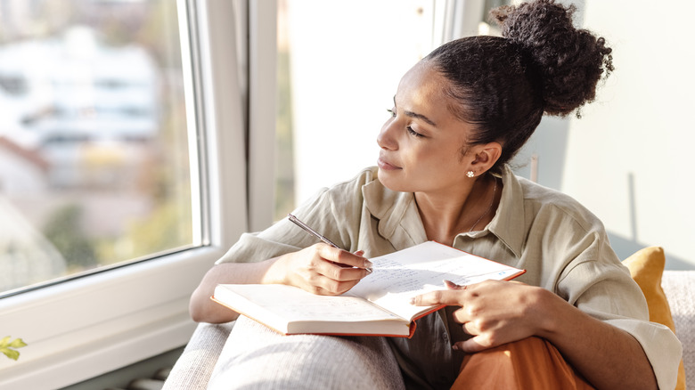 Woman writing in journal