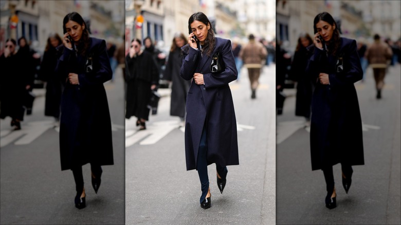 woman wearing a navy blue trench 