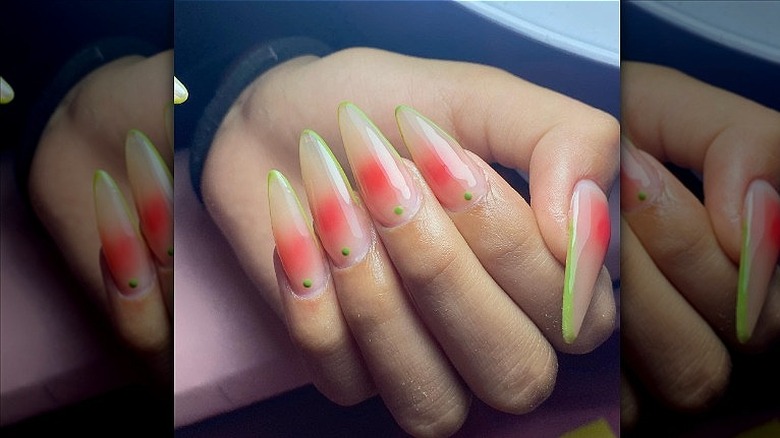  woman with pink and green nails 