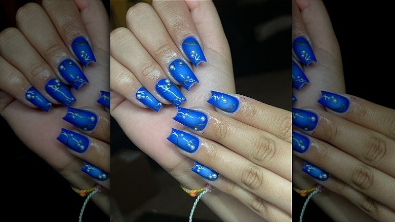 woman with neon blue aura nails