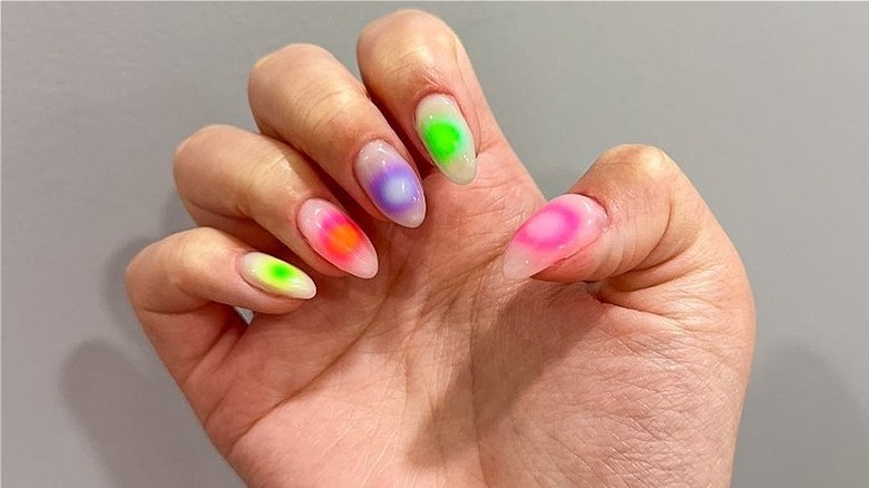 woman with neon aura nails