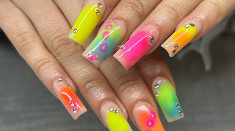 woman with neon aura gem manicure