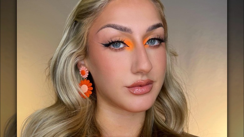 Neon orange inner eye corner makeup