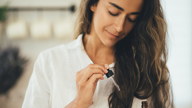 woman using hair oil