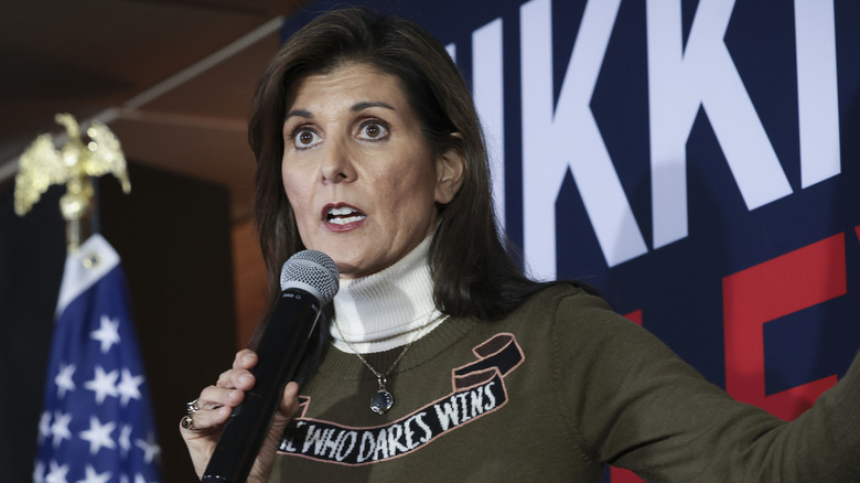 Nikki Haley on stage wearing a sweater reading 