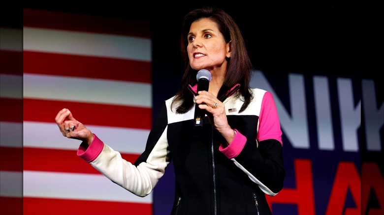 Nikki Haley wearing a black, white, and pink atheletic top on stage.