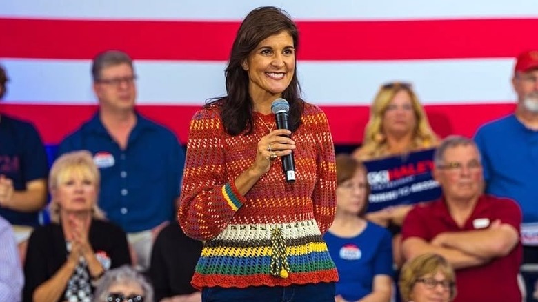 Nikki Haley wearing a colorful bohemian sweater on stage.