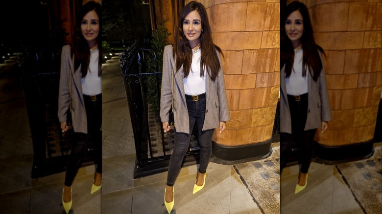 Brunette wearing blazer, yellow pumps