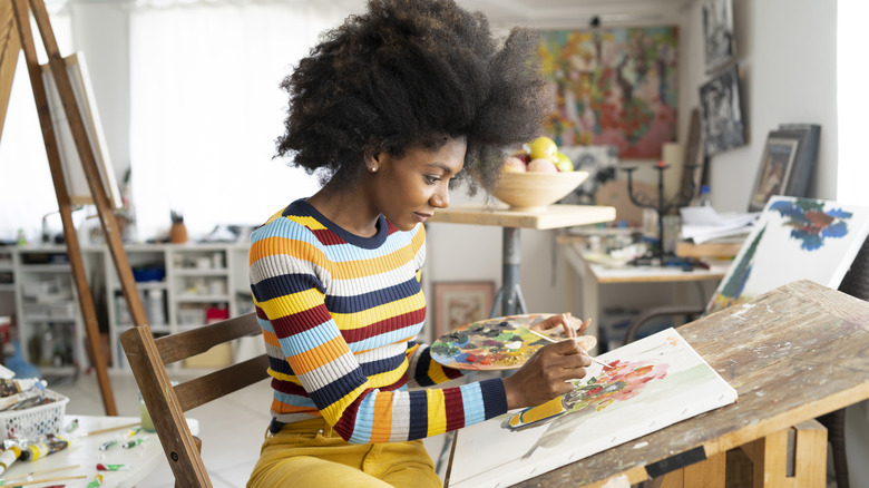 woman painting on canvas