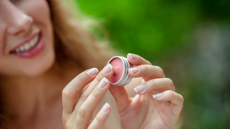 Woman using lip balm