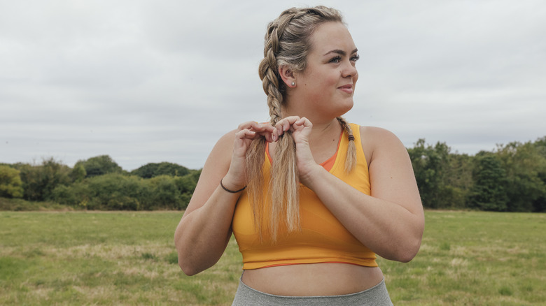 Woman doing braids on her hair