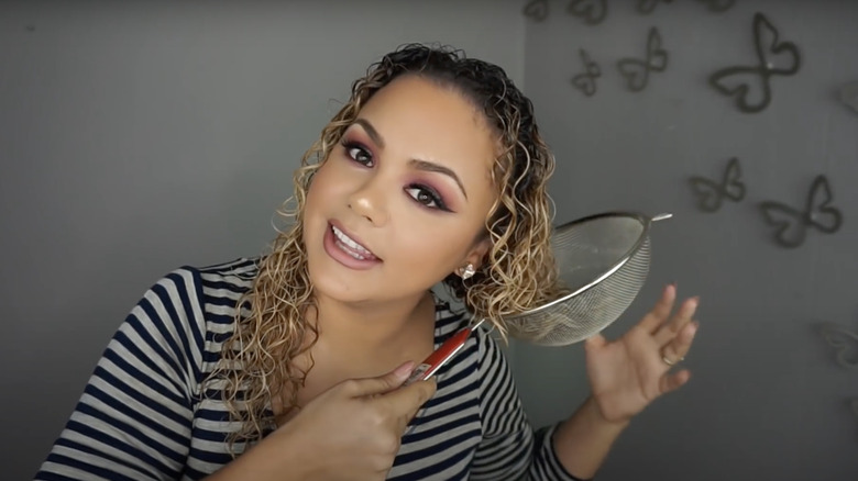 woman drying hair with strainer