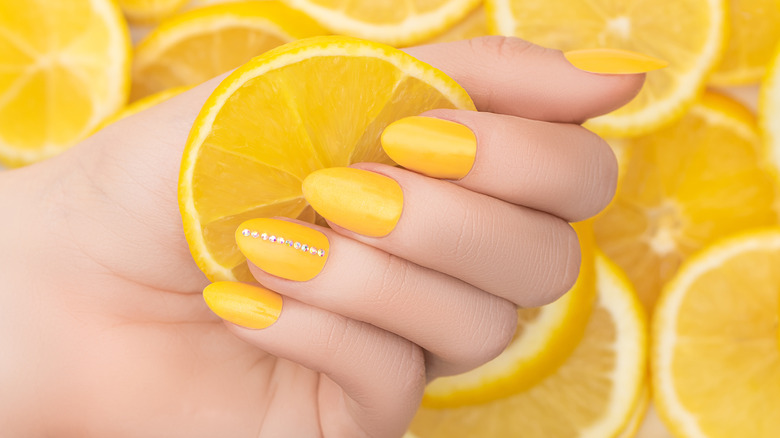 Person holding lemon.