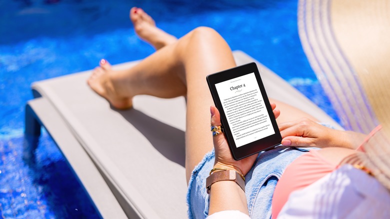 woman using e-reader on vacation