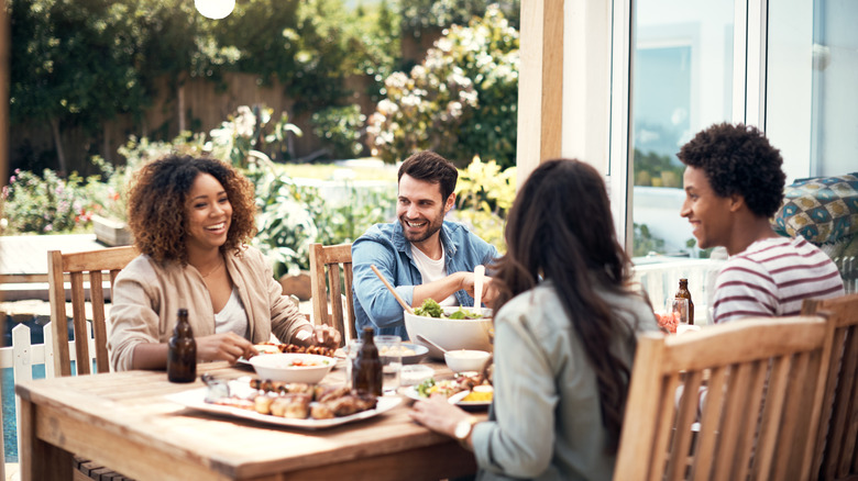 Four people enjoying dinner