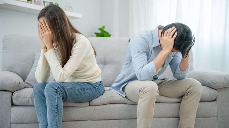 couple fighting on couch