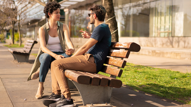 couple talking on a bench