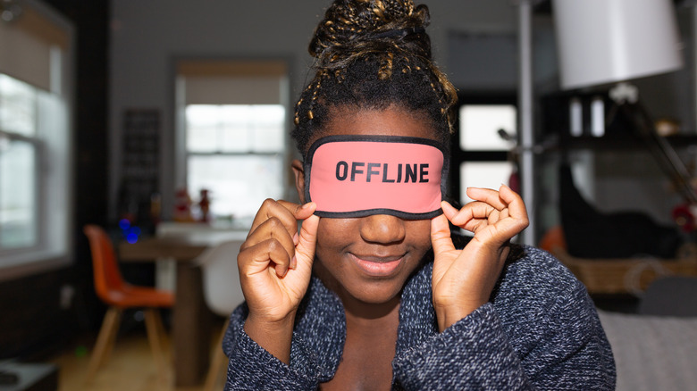 woman wears 'offline' face mask
