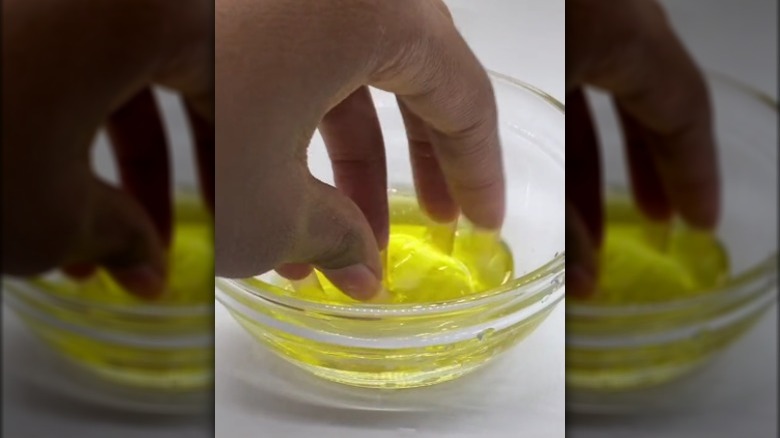 dipping fingers in olive oil