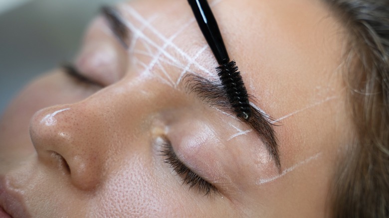 Woman getting eyebrow mapping