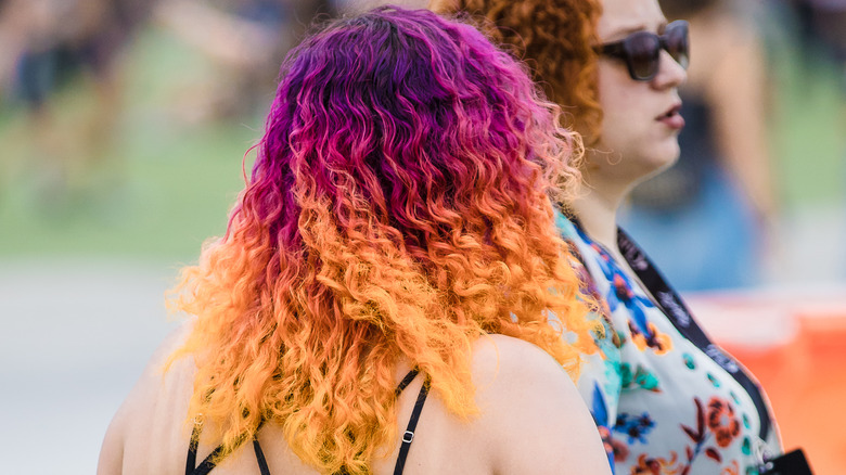 Woman with purple-to-orange ombré hair