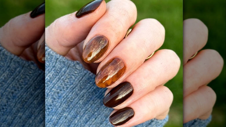 Person displaying tortoise shell manicure