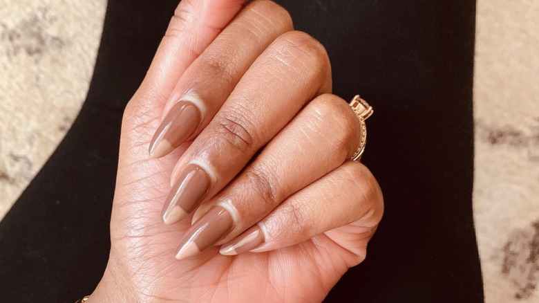 Person showing off brown-hued manicure