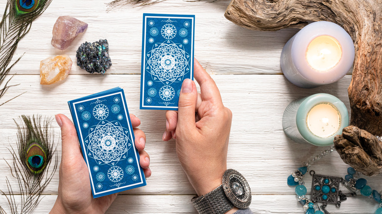 Person holding tarot card deck