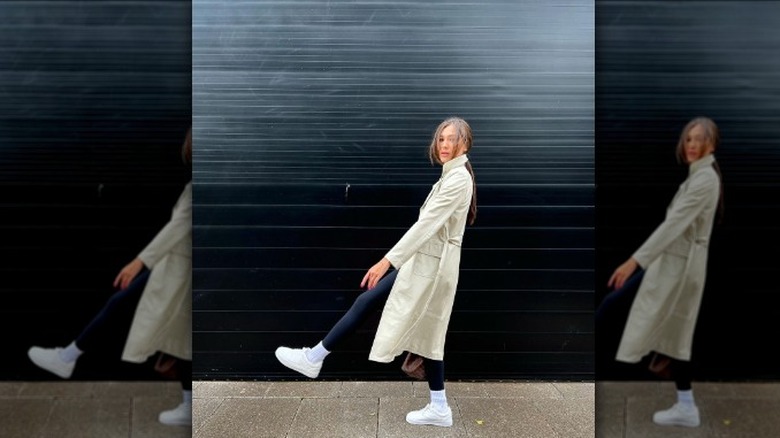 Tan leather trenchcoat with black leggings