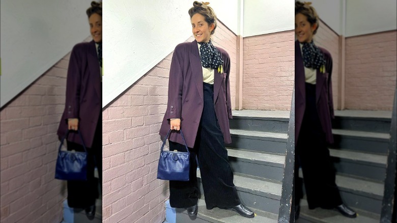 Woman in oversized pants and coat with shoulder pads 