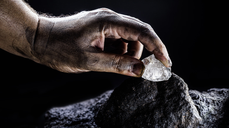 Miner handles gemstone