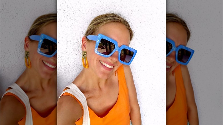 Girl wearing blue sunglasses and earrings