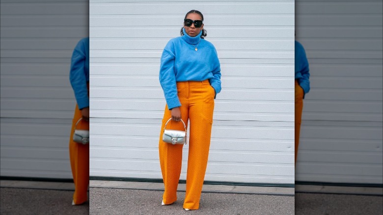 Girl wearing color-blocked blue and orange.